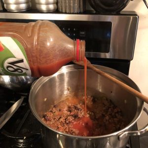 v8 pouring into the chili