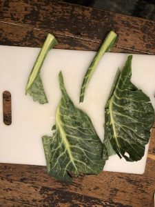 slicing out stem of collard greens